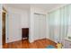 Cozy bedroom featuring hardwood floors, a closet, and two entry doors at 4218 E 18Th St, Indianapolis, IN 46218