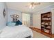 Serene bedroom featuring hardwood floors, a ceiling fan, and closet space at 4218 E 18Th St, Indianapolis, IN 46218