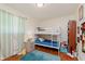 Bright bedroom with a bunk bed, hardwood floors, and a colorful accent rug at 4218 E 18Th St, Indianapolis, IN 46218