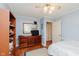 Comfortable bedroom featuring light blue walls, hardwood floors, and a ceiling fan at 4218 E 18Th St, Indianapolis, IN 46218