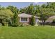 Picture of a charming single-story home with well-manicured lawn, mature trees, and brick at 4218 E 18Th St, Indianapolis, IN 46218