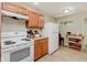 Functional kitchen equipped with white appliances, wooden cabinets, and efficient layout at 4218 E 18Th St, Indianapolis, IN 46218