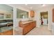 Practical kitchen with wood cabinets, neutral countertops, and view of the living room at 4218 E 18Th St, Indianapolis, IN 46218