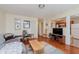 Open living room featuring hardwood floors, comfortable seating, and views into the kitchen at 4218 E 18Th St, Indianapolis, IN 46218