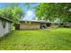 Lush backyard featuring a tool shed, green lawn, and a brick exterior; ideal for outdoor relaxation at 4340 Ashbourne Ln, Indianapolis, IN 46226