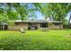 Spacious backyard with green lawn and brick house, showcasing an outdoor living space ideal for entertainment at 4340 Ashbourne Ln, Indianapolis, IN 46226