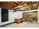 Unfinished basement with exposed wood ceiling and room for storage with built-in shelves at 4340 Ashbourne Ln, Indianapolis, IN 46226