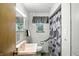 Bathroom with white tile, pink sink, and decorative shower curtain at 4340 Ashbourne Ln, Indianapolis, IN 46226