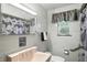 Bathroom featuring a pink sink, white tile, and modern decor at 4340 Ashbourne Ln, Indianapolis, IN 46226