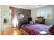 Comfortable bedroom with wood floors, stylish wallpaper, and lots of natural light at 4340 Ashbourne Ln, Indianapolis, IN 46226