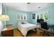 Airy bedroom with a desk, chair, and light blue walls at 4340 Ashbourne Ln, Indianapolis, IN 46226