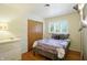 Bedroom featuring a double bed, a wardrobe, and light hardwood floors at 4340 Ashbourne Ln, Indianapolis, IN 46226
