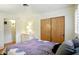 Bedroom with a double bed, white dresser, and wooden closet at 4340 Ashbourne Ln, Indianapolis, IN 46226
