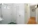 Welcoming entryway with white walls and doors, complemented by hardwood and green patterned flooring at 4340 Ashbourne Ln, Indianapolis, IN 46226