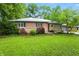 Inviting single-story home with a brick facade, tidy landscaping, and green lawn at 4340 Ashbourne Ln, Indianapolis, IN 46226
