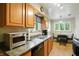 Traditional kitchen with wood cabinets, granite countertops, and stainless steel appliances at 4340 Ashbourne Ln, Indianapolis, IN 46226