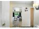 Open doorway to a carpeted living room featuring a ceiling fan and large picture window at 4340 Ashbourne Ln, Indianapolis, IN 46226