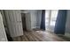 Bedroom with neutral gray walls, wood-look floors, closet, and natural light from the window at 435 N Rural Ne St, Indianapolis, IN 46201