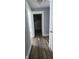 Hallway with wood-look flooring offering access to the bathroom with a tub and shower at 435 N Rural Ne St, Indianapolis, IN 46201