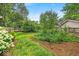 Beautifully landscaped backyard with mature trees and shrubs provides a serene outdoor space at 4356 N College Ave, Indianapolis, IN 46205