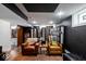 A finished basement offers a cozy space with vinyl storage and two leather chairs at 4356 N College Ave, Indianapolis, IN 46205