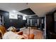 The finished basement area boasts sleek black walls and includes a music listening area at 4356 N College Ave, Indianapolis, IN 46205
