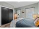 Bright bedroom featuring hardwood floors, closet, and natural light from two windows at 4356 N College Ave, Indianapolis, IN 46205