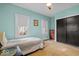 Cozy bedroom with hardwood floors, closet, and natural light from two windows at 4356 N College Ave, Indianapolis, IN 46205