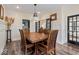 Formal dining room featuring wainscoting, hardwood floors, and modern lighting fixture at 4356 N College Ave, Indianapolis, IN 46205