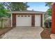 A detached garage featuring wood shingles, white trim, a white door and carriage lights above the door at 4356 N College Ave, Indianapolis, IN 46205