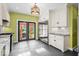 Kitchen with modern appliances, gray tile floors, and a view of the yard at 4356 N College Ave, Indianapolis, IN 46205