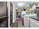 The laundry room has lots of storage, washer, dryer, utility sink, and tiled flooring at 4356 N College Ave, Indianapolis, IN 46205
