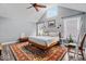Open bedroom with vaulted ceilings, many windows, hardwood floors, and a ceiling fan at 4356 N College Ave, Indianapolis, IN 46205