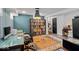 Basement office space with built-in storage and a modern glass desk with an ergonomic chair at 4356 N College Ave, Indianapolis, IN 46205