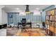 The basement office features blue accent wall, built in storage, and a modern desk at 4356 N College Ave, Indianapolis, IN 46205