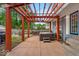 Outdoor patio with hot tub and dining set under a wood pergola perfect for entertaining at 4356 N College Ave, Indianapolis, IN 46205