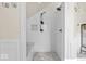Modern all-tile walk-in shower with bench, rainfall showerhead, and built-in niche at 4356 N College Ave, Indianapolis, IN 46205