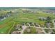 Aerial view showcasing a home on a golf course with a beautiful pond and lush greenery at 4434 Hickory Ridge Blvd, Greenwood, IN 46143