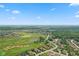 Aerial view of a neighborhood featuring homes on a golf course surrounded by mature trees at 4434 Hickory Ridge Blvd, Greenwood, IN 46143