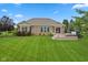 Expansive backyard featuring a brick home, lush lawn, and a deck with a built-in hot tub at 4434 Hickory Ridge Blvd, Greenwood, IN 46143