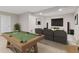 Basement featuring a pool table and a seating area with a large television at 4434 Hickory Ridge Blvd, Greenwood, IN 46143