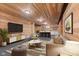 Modern basement features wood paneled walls and ceilings, a bar area, and comfortable seating at 4434 Hickory Ridge Blvd, Greenwood, IN 46143