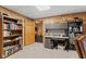 Basement office leading to home gym space with shelves and built in desk offer a quiet place to work at 4434 Hickory Ridge Blvd, Greenwood, IN 46143