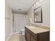 Neutral bathroom featuring a granite vanity top, dark wood cabinets, and a shower with a patterned curtain at 4434 Hickory Ridge Blvd, Greenwood, IN 46143