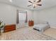 Neutral bedroom with light tile floors, a ceiling fan, and a patterned area rug at 4434 Hickory Ridge Blvd, Greenwood, IN 46143