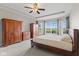 Bright main bedroom featuring tray ceilings, wardrobes, and large windows with scenic views at 4434 Hickory Ridge Blvd, Greenwood, IN 46143