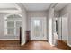Inviting foyer with wood floors, decorative front door, and lots of natural light at 4434 Hickory Ridge Blvd, Greenwood, IN 46143