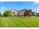 Beautiful brick home with well-manicured lawn, mature trees, and professional landscaping at 4434 Hickory Ridge Blvd, Greenwood, IN 46143