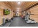 Well-equipped home gym with wood walls, weightlifting equipment, and a treadmill at 4434 Hickory Ridge Blvd, Greenwood, IN 46143