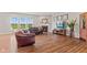 Inviting living room with hardwood floors, fireplace, and large windows with natural light at 4434 Hickory Ridge Blvd, Greenwood, IN 46143